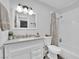 Bright bathroom features a white vanity, stone countertop, and shower with white subway tiles at 942 Westminster Ave, Las Vegas, NV 89119