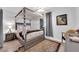 Comfortable bedroom with canopy bed, neutral decor and accent rug at 942 Westminster Ave, Las Vegas, NV 89119
