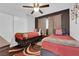 Bright bedroom featuring a ceiling fan, stylish accent wall, and cozy carpet for added comfort at 942 Westminster Ave, Las Vegas, NV 89119