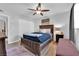 Bright bedroom featuring wood floors, ceiling fan and stylish decor creating a cozy and inviting space at 942 Westminster Ave, Las Vegas, NV 89119