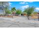 Charming single-story home with a landscaped front yard, driveway, and modern fence at 942 Westminster Ave, Las Vegas, NV 89119