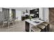 Modern kitchen with dark cabinetry, stainless steel appliances, and a breakfast bar at 942 Westminster Ave, Las Vegas, NV 89119