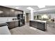 Stylish kitchen with dark cabinets, quartz countertops, stainless appliances, and wood-look floors at 942 Westminster Ave, Las Vegas, NV 89119