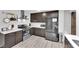 Updated kitchen with stainless steel appliances, gray cabinets, and light countertops at 942 Westminster Ave, Las Vegas, NV 89119