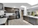 Well-lit kitchen featuring stainless steel appliances, dark cabinets, and white countertops at 942 Westminster Ave, Las Vegas, NV 89119
