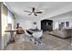 Well-lit living room featuring an open floor plan with stylish decor and a modern ceiling fan at 942 Westminster Ave, Las Vegas, NV 89119