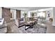 Comfortable living area featuring a sectional sofa, stylish decor, and a view into the dining area at 942 Westminster Ave, Las Vegas, NV 89119