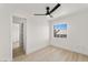 Bedroom with hardwood floors, ceiling fan, closet, and a window to the outside at 9795 La Cienega St, Las Vegas, NV 89183