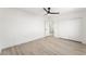 Well-lit bedroom with wood floors, a ceiling fan, and a closet for storage at 9795 La Cienega St, Las Vegas, NV 89183
