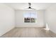 Minimalist bedroom featuring a large window offering ample natural light and a ceiling fan at 9795 La Cienega St, Las Vegas, NV 89183