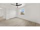 Light bedroom with wood floors, a ceiling fan, closet, and a window with views at 9795 La Cienega St, Las Vegas, NV 89183