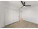 Spacious bedroom featuring wood floors, a ceiling fan, and a closet with sliding doors at 9795 La Cienega St, Las Vegas, NV 89183