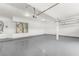 Spacious three-car garage with gray epoxy floors and utilities, great for vehicles or storage at 9795 La Cienega St, Las Vegas, NV 89183