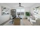 Bright home office with a modern ceiling fan, large windows, and chic furnishings at 9795 La Cienega St, Las Vegas, NV 89183