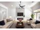 Cozy living room featuring stylish decor, modern fireplace, and large windows for natural light at 10405 Junction Hill Dr, Las Vegas, NV 89134