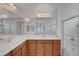 Bright bathroom featuring double sinks, ample counter space, and a glass-enclosed shower at 10410 Poplar Park Ave, Las Vegas, NV 89166