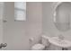 Well-lit powder room featuring a pedestal sink, and crisp white walls at 10410 Poplar Park Ave, Las Vegas, NV 89166