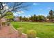 Picturesque view of a community park with walking paths, green lawns, and mature trees at 10410 Poplar Park Ave, Las Vegas, NV 89166