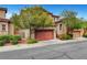 Charming two-story home features a terracotta-colored garage door, lovely landscaping, and inviting curb appeal at 10410 Poplar Park Ave, Las Vegas, NV 89166