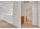 Hallway with storage cabinets and bathroom, all featuring neutral-colored walls and carpeted floors at 10410 Poplar Park Ave, Las Vegas, NV 89166