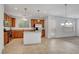 Bright open kitchen with stainless steel appliances, wooden cabinets, and an island at 10410 Poplar Park Ave, Las Vegas, NV 89166