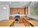 Bright kitchen featuring stainless steel appliances, wood cabinets, and granite countertops at 10410 Poplar Park Ave, Las Vegas, NV 89166