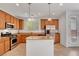 Bright kitchen with stainless steel appliances, wood cabinets, granite countertops, and an island at 10410 Poplar Park Ave, Las Vegas, NV 89166