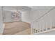 Open-concept living room with staircase, lots of natural light, and neutral decor at 10410 Poplar Park Ave, Las Vegas, NV 89166