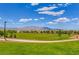 Lush green fields, walking paths and beautiful mountain views highlight this desirable community's amenities at 10410 Poplar Park Ave, Las Vegas, NV 89166