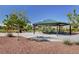 Inviting picnic shelter with tables is surrounded by mature landscaping and a well maintained green space at 10410 Poplar Park Ave, Las Vegas, NV 89166