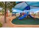 A vibrant community playground with slides, play structures, and sun shade at 10410 Poplar Park Ave, Las Vegas, NV 89166