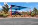 Community playground featuring colorful play structures, sun shade, and landscaped surroundings at 10410 Poplar Park Ave, Las Vegas, NV 89166