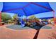A covered community playground provides a safe and enjoyable play area with various play equipment at 10410 Poplar Park Ave, Las Vegas, NV 89166