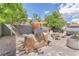 Inviting backyard with a built-in grill, pergola, patio, seating, and lush greenery at 10432 Britton Hill Ave, Las Vegas, NV 89129