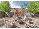 Landscaped backyard featuring a cozy hot tub, fire pit, and comfortable seating area perfect for relaxation at 10432 Britton Hill Ave, Las Vegas, NV 89129