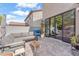 Back patio area with comfortable gray seating and large sliding glass doors to the interior at 10432 Britton Hill Ave, Las Vegas, NV 89129