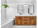 Bathroom featuring a soaking tub, glass shower, double vanity, and modern lighting at 10432 Britton Hill Ave, Las Vegas, NV 89129