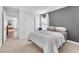 Cozy bedroom with neutral tones, a comfortable bed, and a door to the living area at 10432 Britton Hill Ave, Las Vegas, NV 89129