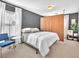 Relaxing bedroom with an accent wall, modern furniture, and ample natural light at 10432 Britton Hill Ave, Las Vegas, NV 89129