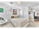 Bright bedroom featuring a cozy chair, large windows, and trendy decor at 10432 Britton Hill Ave, Las Vegas, NV 89129