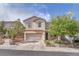 Charming two-story home showcasing manicured landscaping, neutral colors, and an attached two-car garage at 10432 Britton Hill Ave, Las Vegas, NV 89129