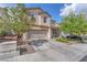 Beautiful home displaying a well-manicured lawn, neutral colors, and attached two-car garage at 10432 Britton Hill Ave, Las Vegas, NV 89129