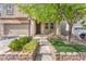 Home exterior showcasing a lush landscaped front yard with a well-maintained lawn and walkway at 10432 Britton Hill Ave, Las Vegas, NV 89129