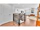 Bright hallway with hardwood floors leading to an open living space with modern decor and a TV at 10432 Britton Hill Ave, Las Vegas, NV 89129