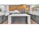 Spacious kitchen with an island, sleek countertops, and modern wooden cabinetry at 10432 Britton Hill Ave, Las Vegas, NV 89129