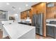 Modern kitchen with wooden cabinets, white countertops, and stainless steel appliances at 10432 Britton Hill Ave, Las Vegas, NV 89129