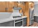 Gourmet kitchen with custom wood cabinets, stainless steel appliances, and stylish white subway tile backsplash at 10432 Britton Hill Ave, Las Vegas, NV 89129