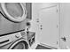 Well-organized laundry room featuring stacked washer and dryer, custom cabinets, and a modern design at 10432 Britton Hill Ave, Las Vegas, NV 89129