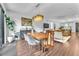 Open-concept living and dining area with wood floors and backyard access at 10432 Britton Hill Ave, Las Vegas, NV 89129