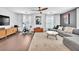 Spacious living room featuring dark hardwood flooring, neutral paint, ceiling fan and comfortable sofa at 10432 Britton Hill Ave, Las Vegas, NV 89129
